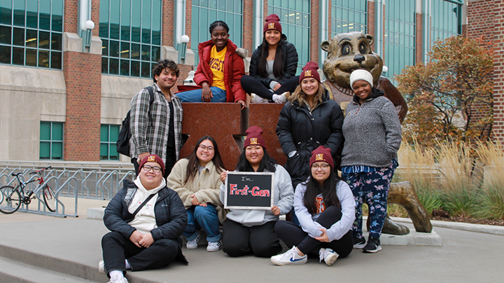 Group of first-gen students posing with Goldy statue.